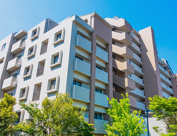 青空と緑に囲まれた集合住宅の外観